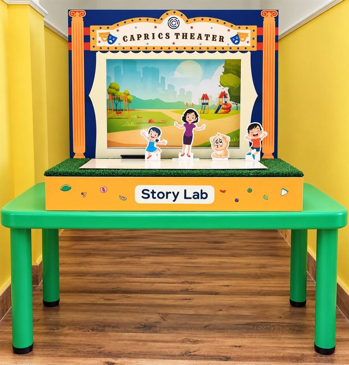The Story Lab — a Caprics Theater puppet stage with a painted park backdrop and standing character cut-outs of a girl, a teacher, a puppy and a boy